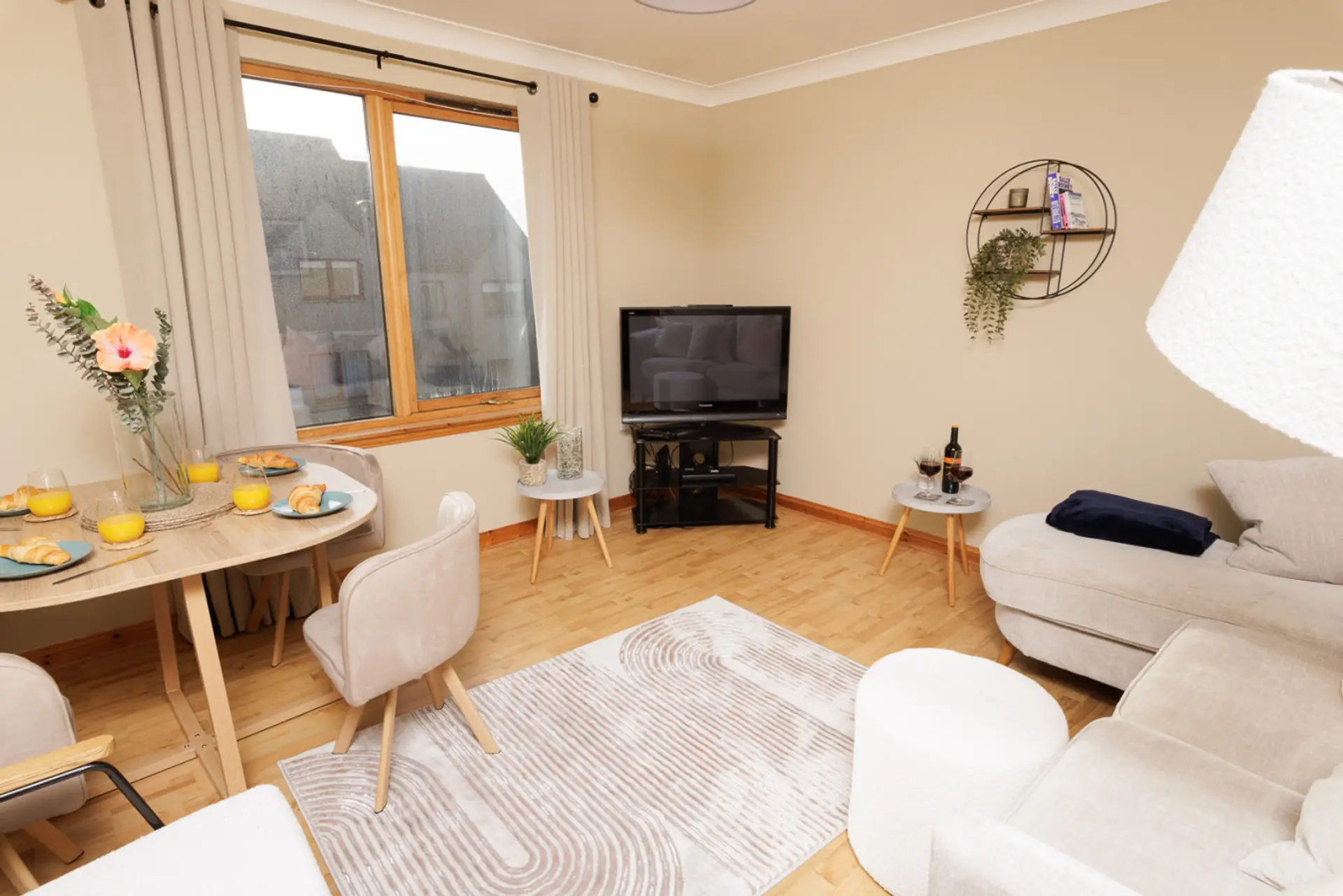 Bright living and dining area with TV