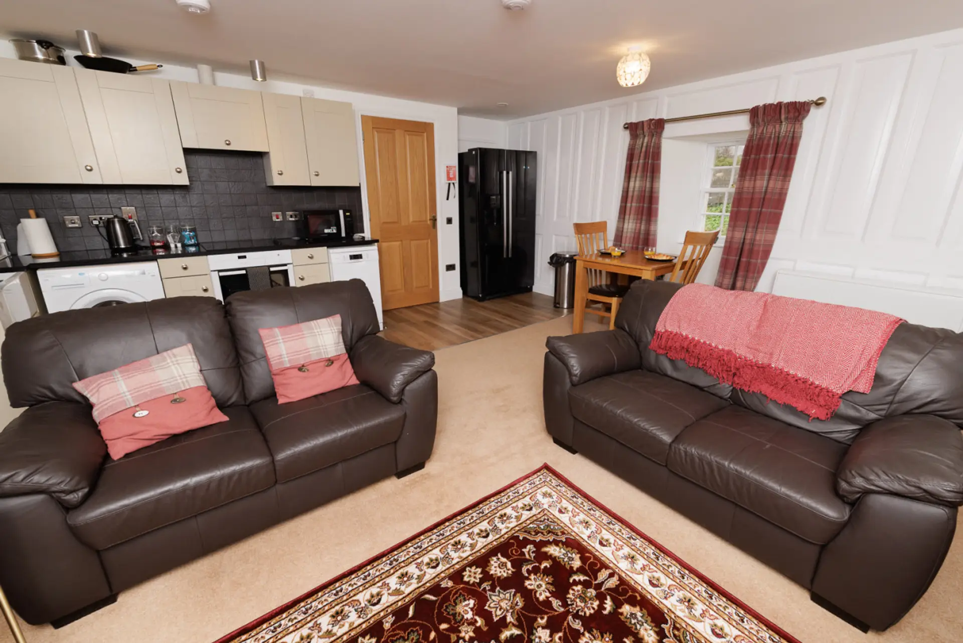 Open-plan living and dining area with a well-equipped kitchen