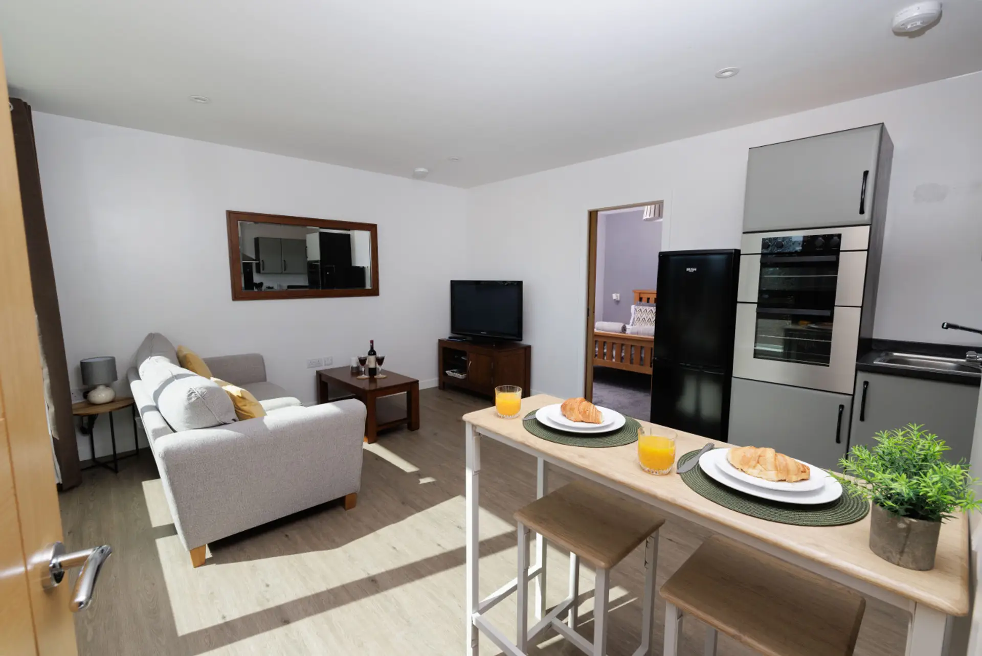 Open-plan living area with seating, dining space, and kitchen