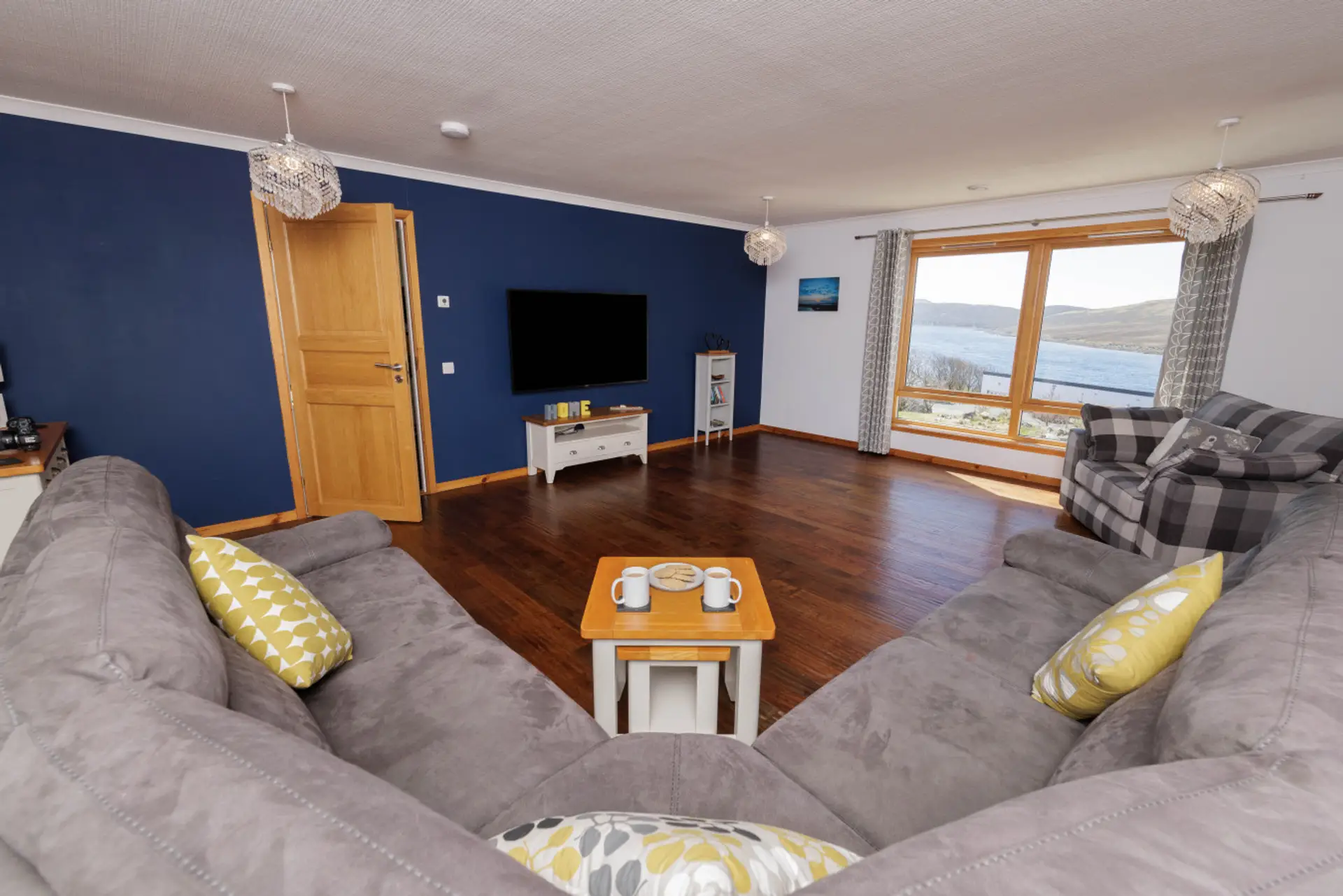 Spacious living area with large windows and water views