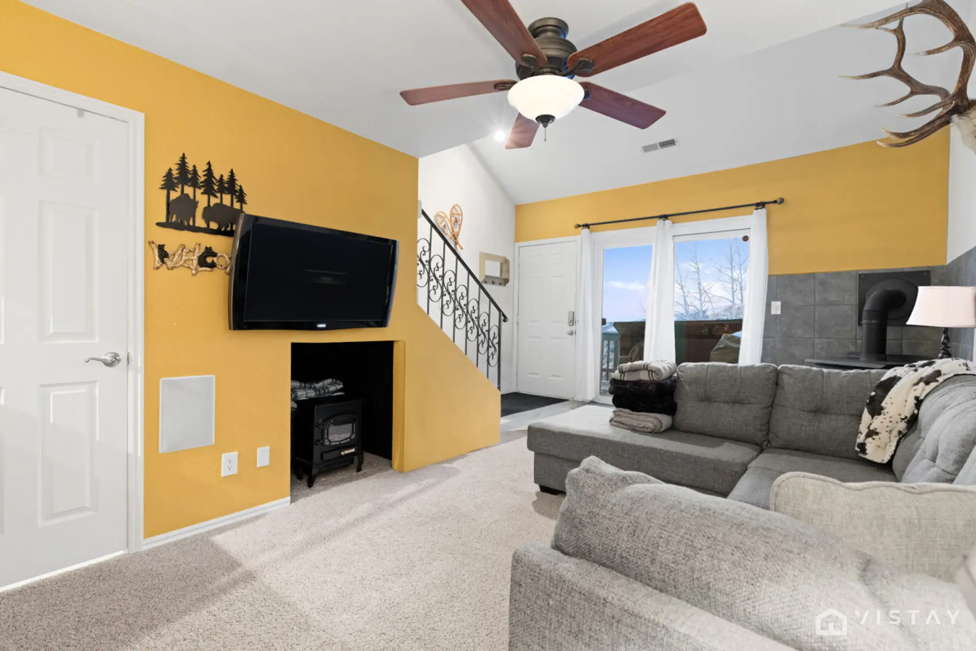 Unwind in the spacious living room, featuring a cozy sofa bed, flat-screen TV, and an inviting indoor fireplace.