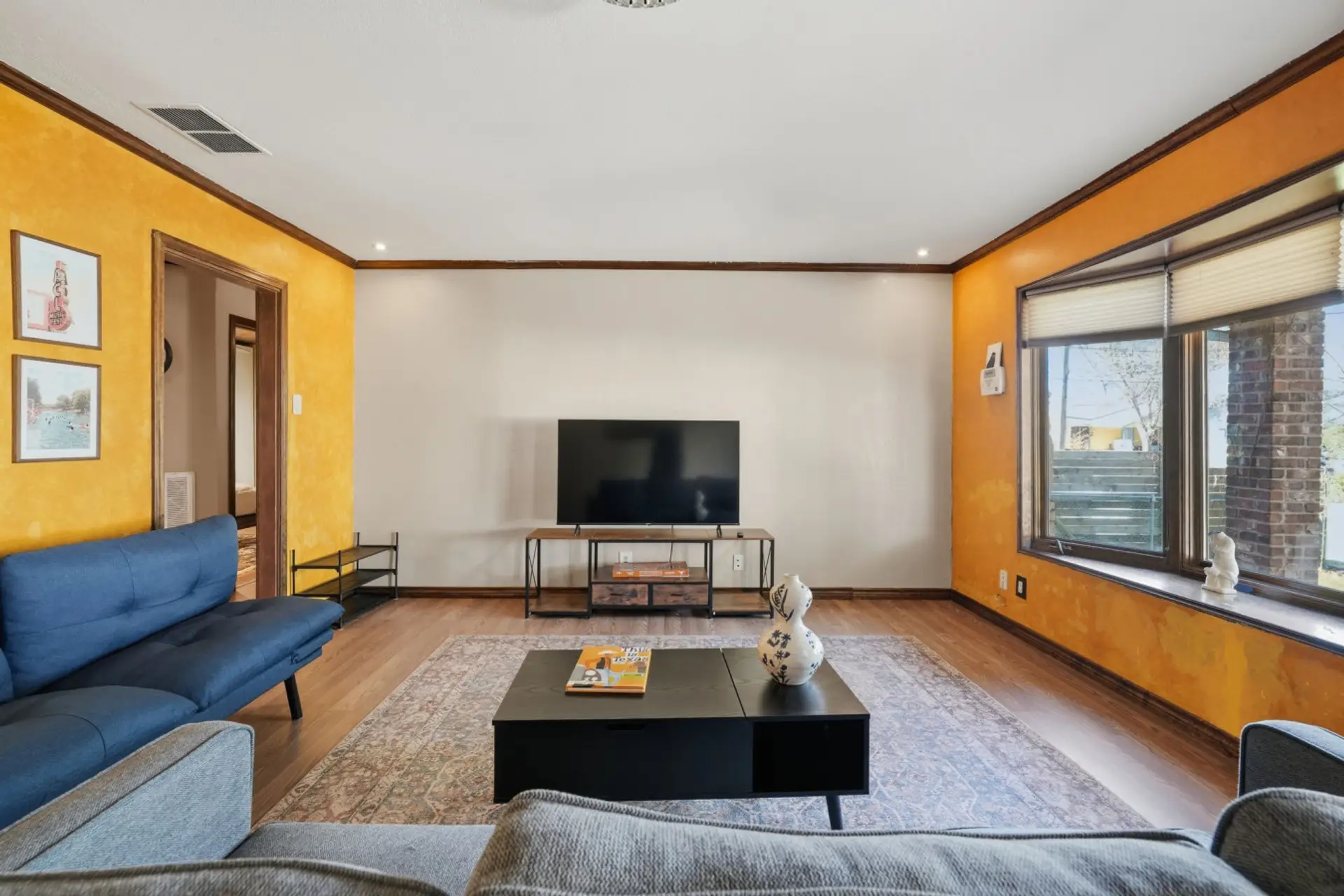 Comfortable living room with tv, good natural light and plenty of space to relax or gather with friends.
