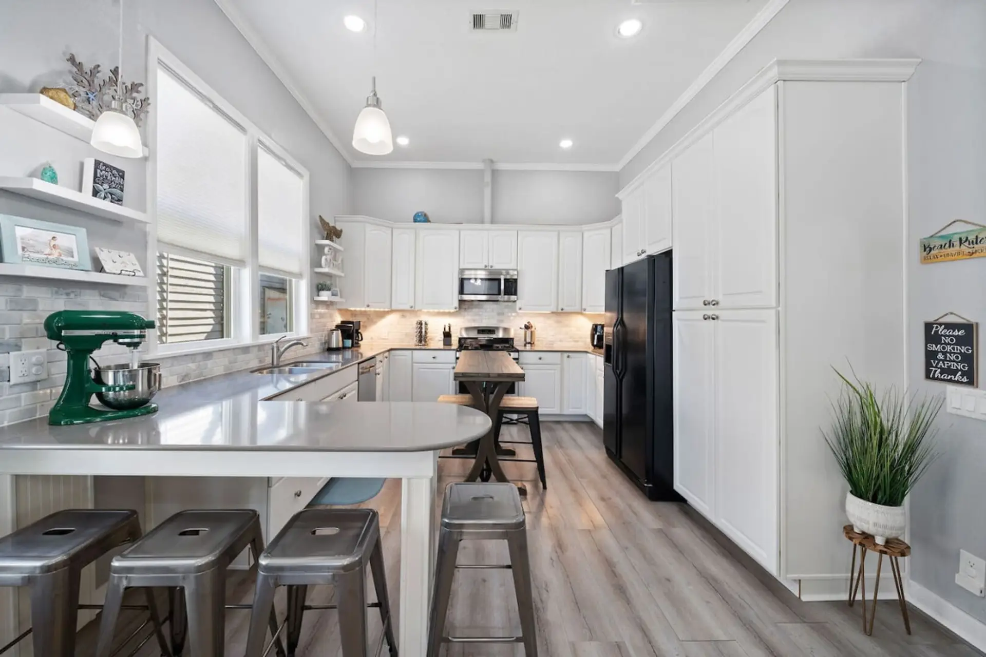 Bright coastal kitchen with island seating in Galveston beach house
