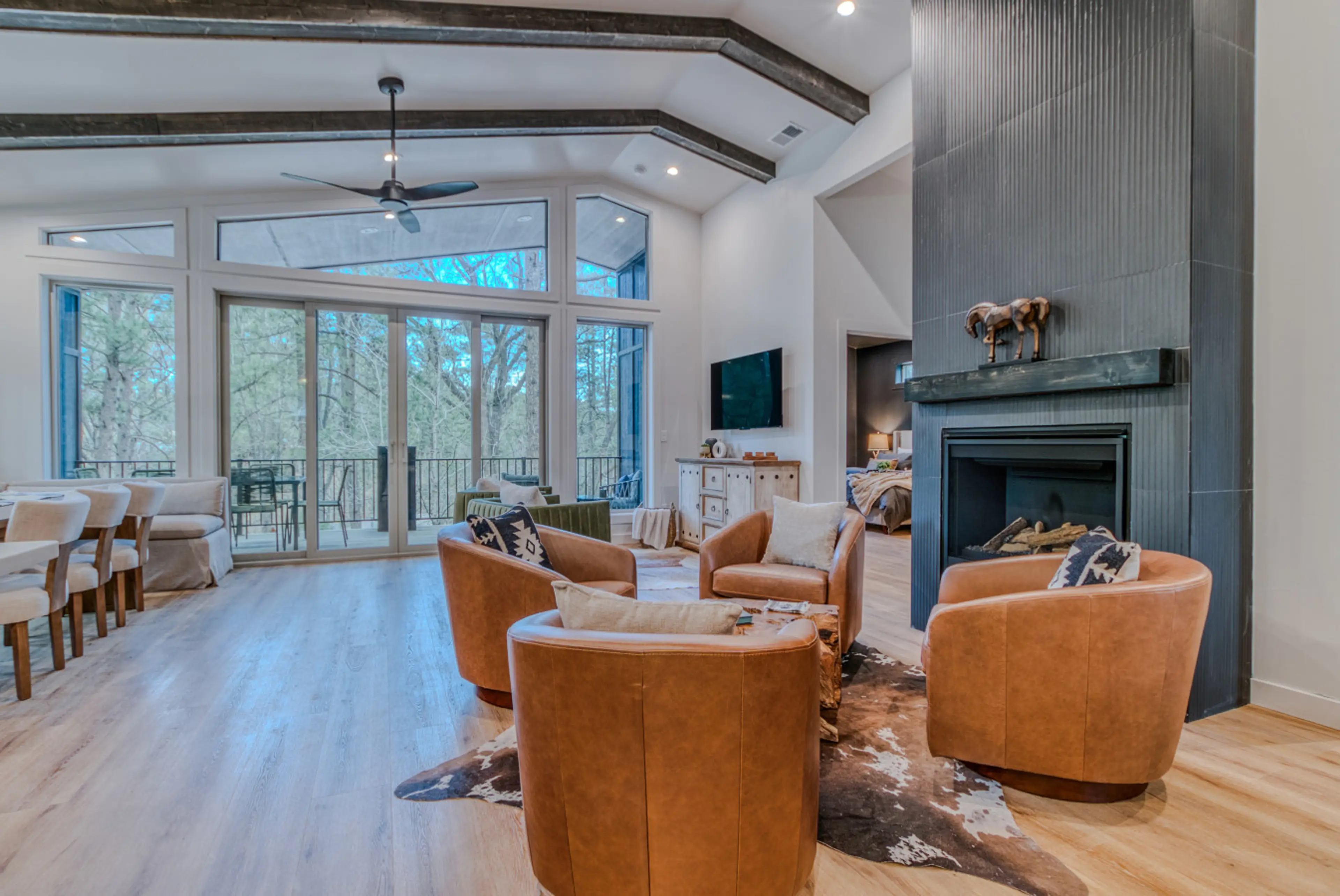 Gather under soaring ceilings with forest views in this light-filled luxury cabin near Midtown Ruidoso