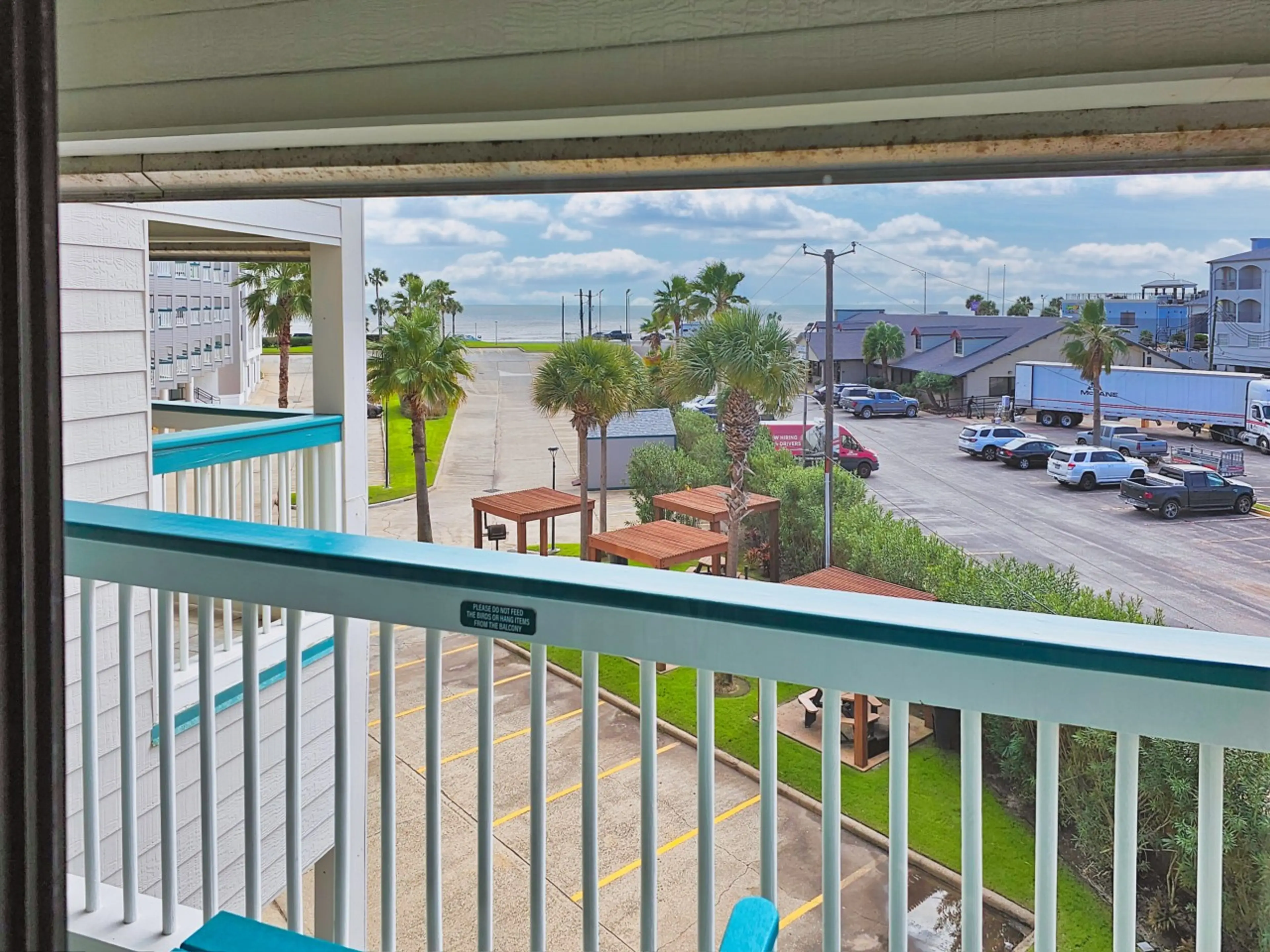 Private balcony at Condo #292 with coastal breezes and a lively Seawall view—perfect for morning coffee and laid-back people watching.