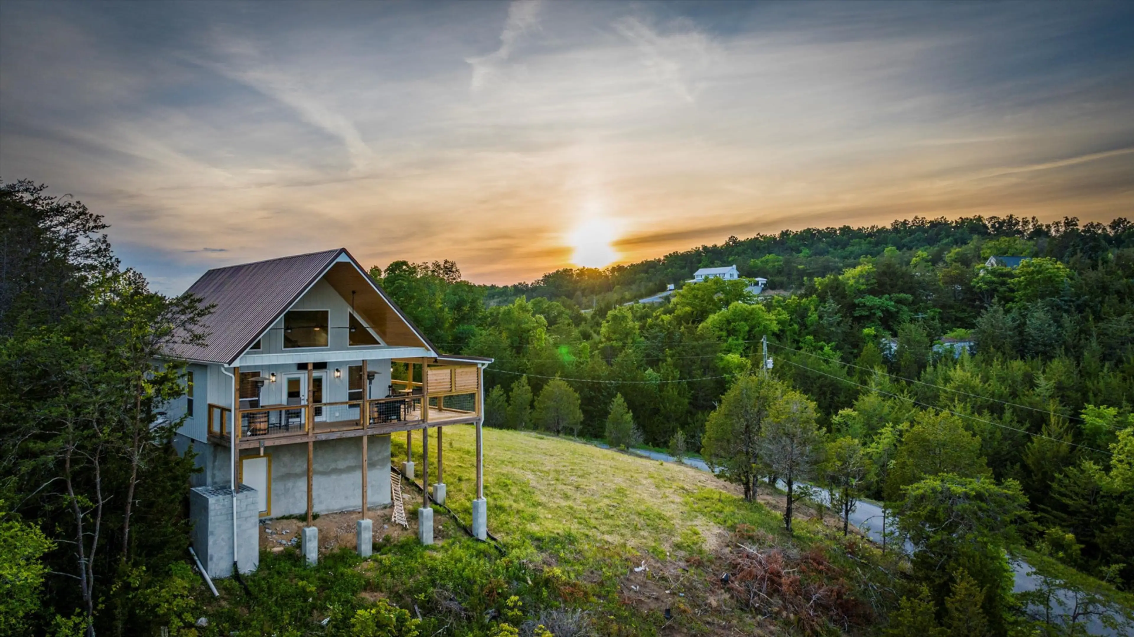 Watch the Smokies glow as the sun sets over Tennessee Whiskey Cabin