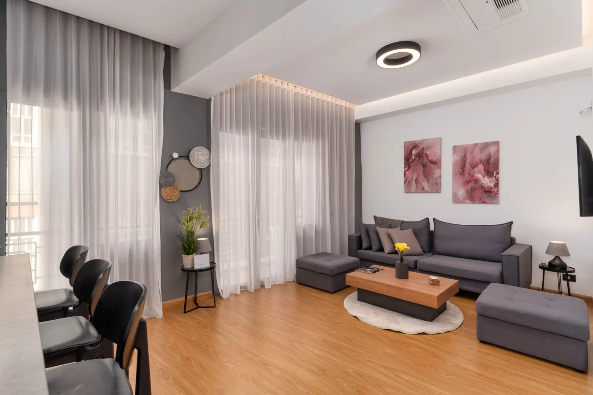 A luminous living space blending modern art, minimalist design, and serene energy — where light, texture, and symmetry create calm in the heart of Exarcheia.