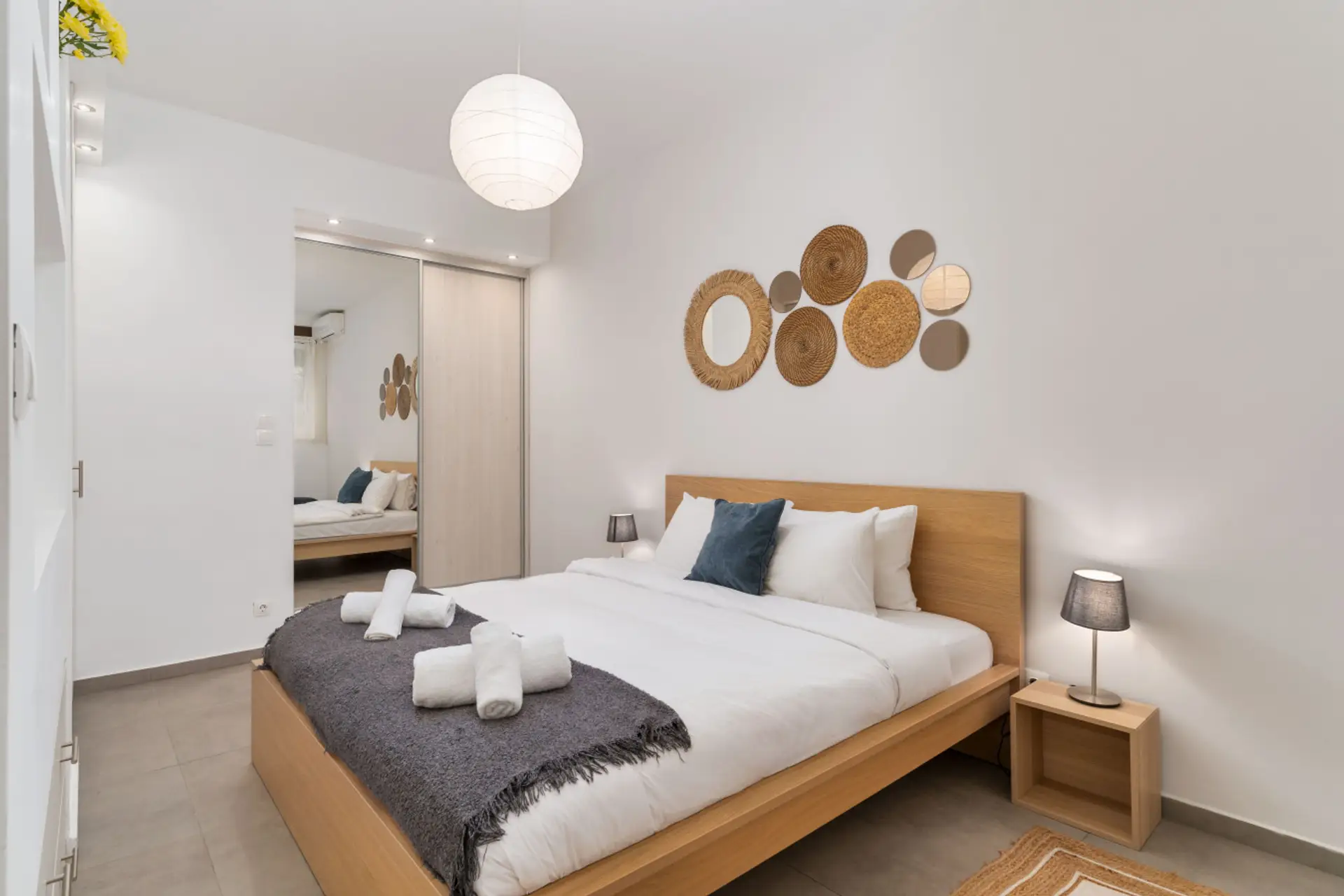 Serene queen-size bedroom with warm tones, soft lighting, and handcrafted wall decor.