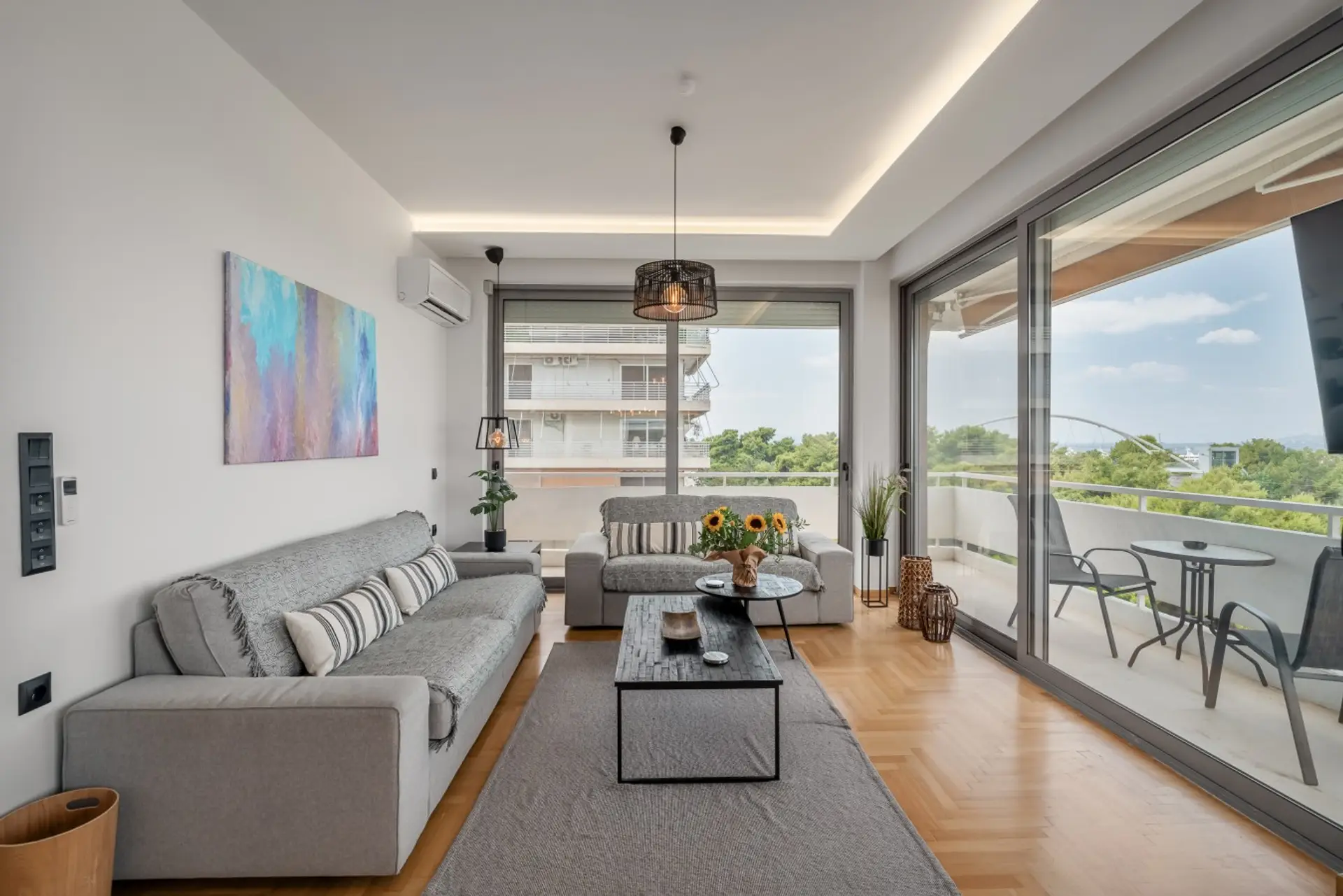 Bright living room with two sofas and balcony views