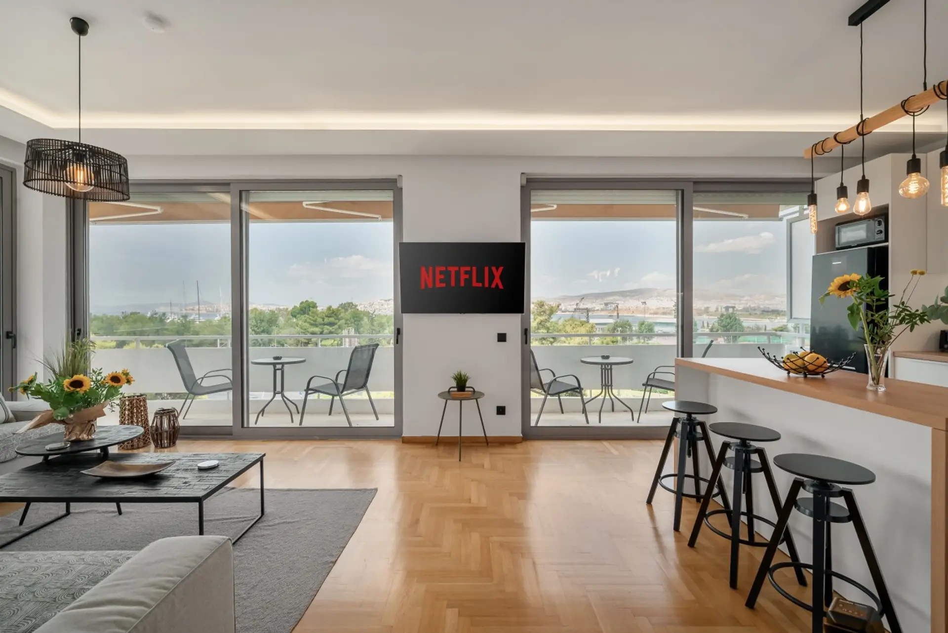 Open-plan living and kitchen with balcony access