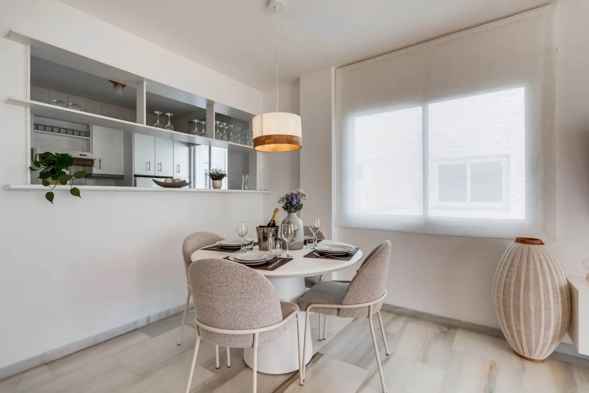 - Dining area with kitchen pass through and modern seating - Bright indoor dining space with natural tones and light - Comfortable vacation rental dining area for shared meals