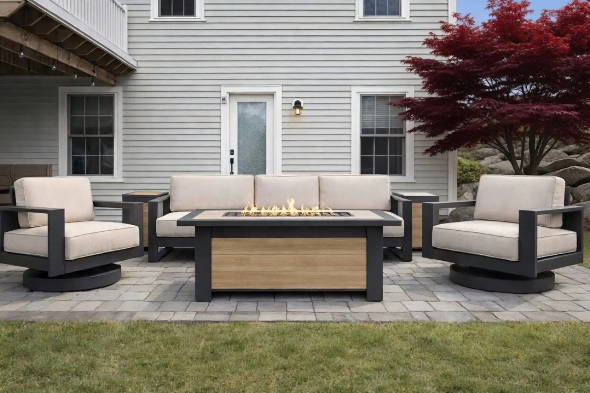 Relax on this spacious outdoor patio featuring a modern fire pit seating set with comfortable swivel chairs and a large sofa. Enjoy cozy evenings around the flickering gas fire table while overlooking the beautifully landscaped yard with mature trees and 