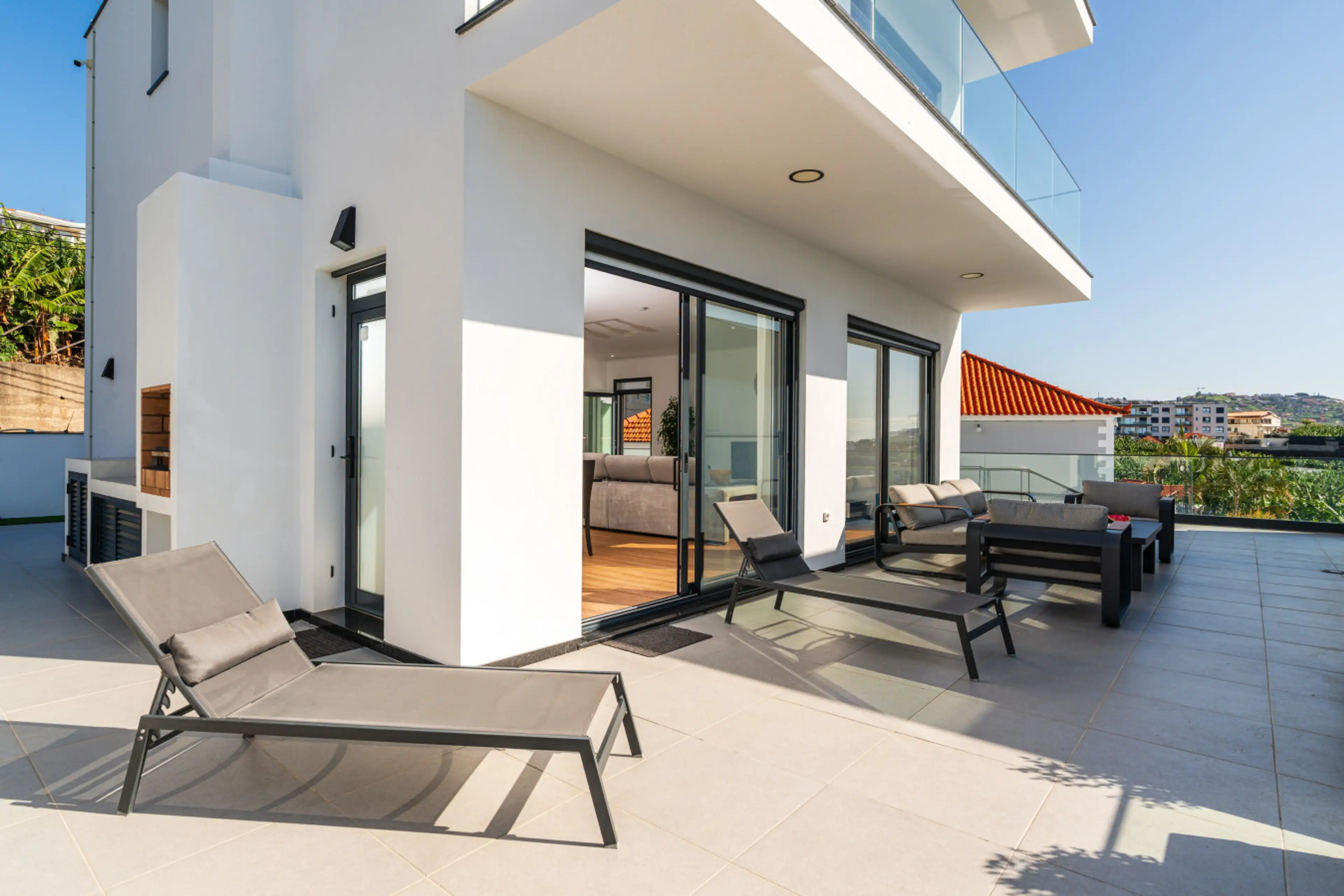 Experience generous outdoor living with sun loungers and open views across Madeira Island.