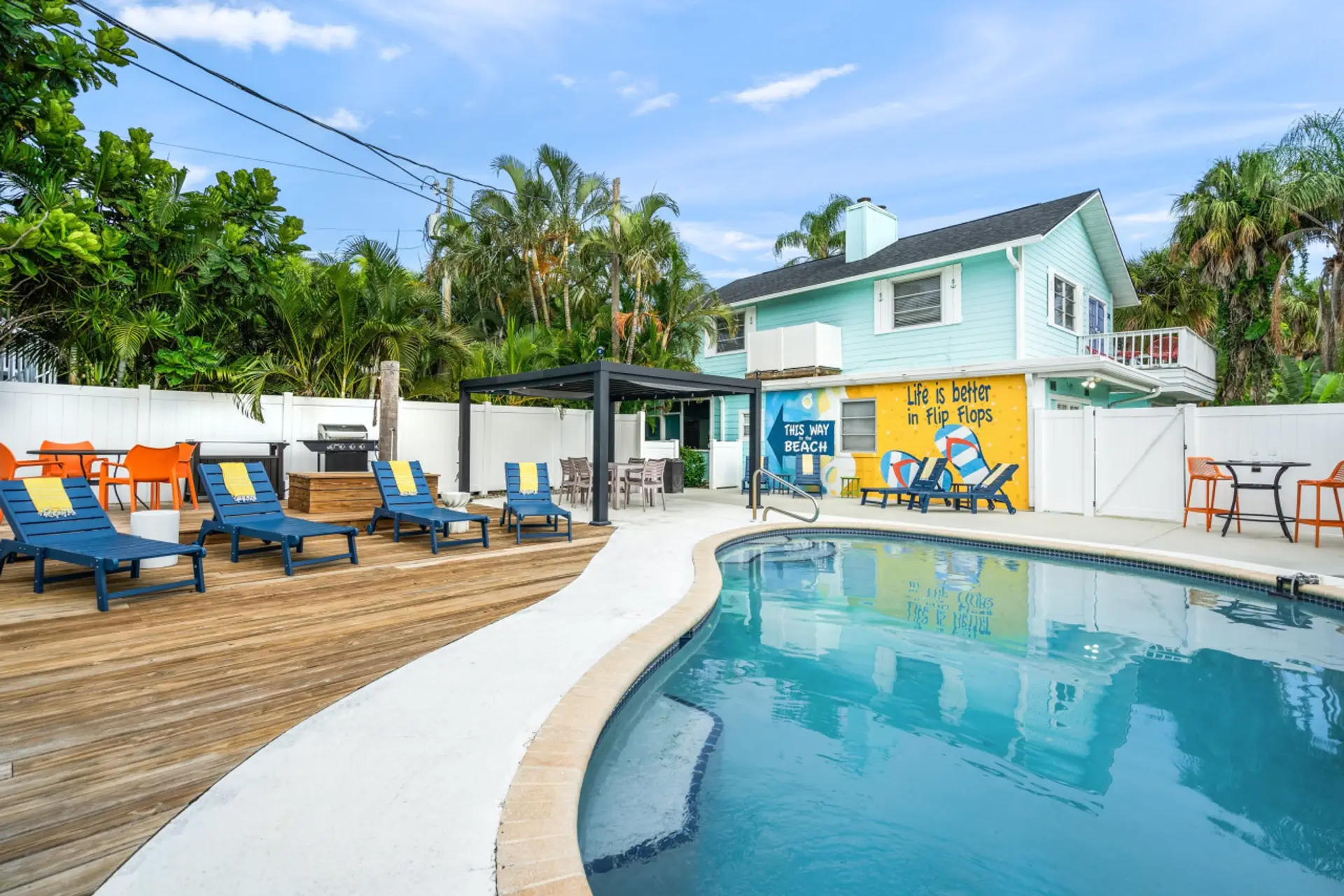 Siesta Key Beach Guest-Only Heated Pool | Curved Layout, Vibrant Flip-Flop Mural & Loungers Shaded by Palms