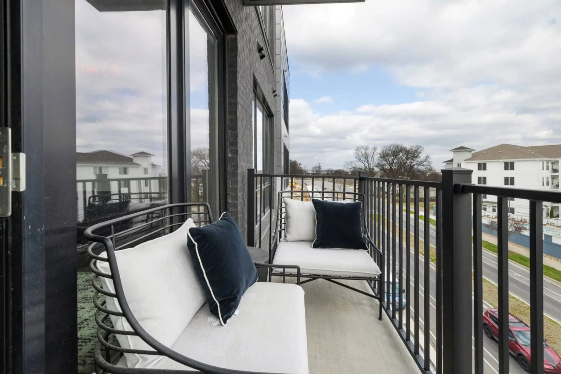 Bright balcony with outdoor seating.