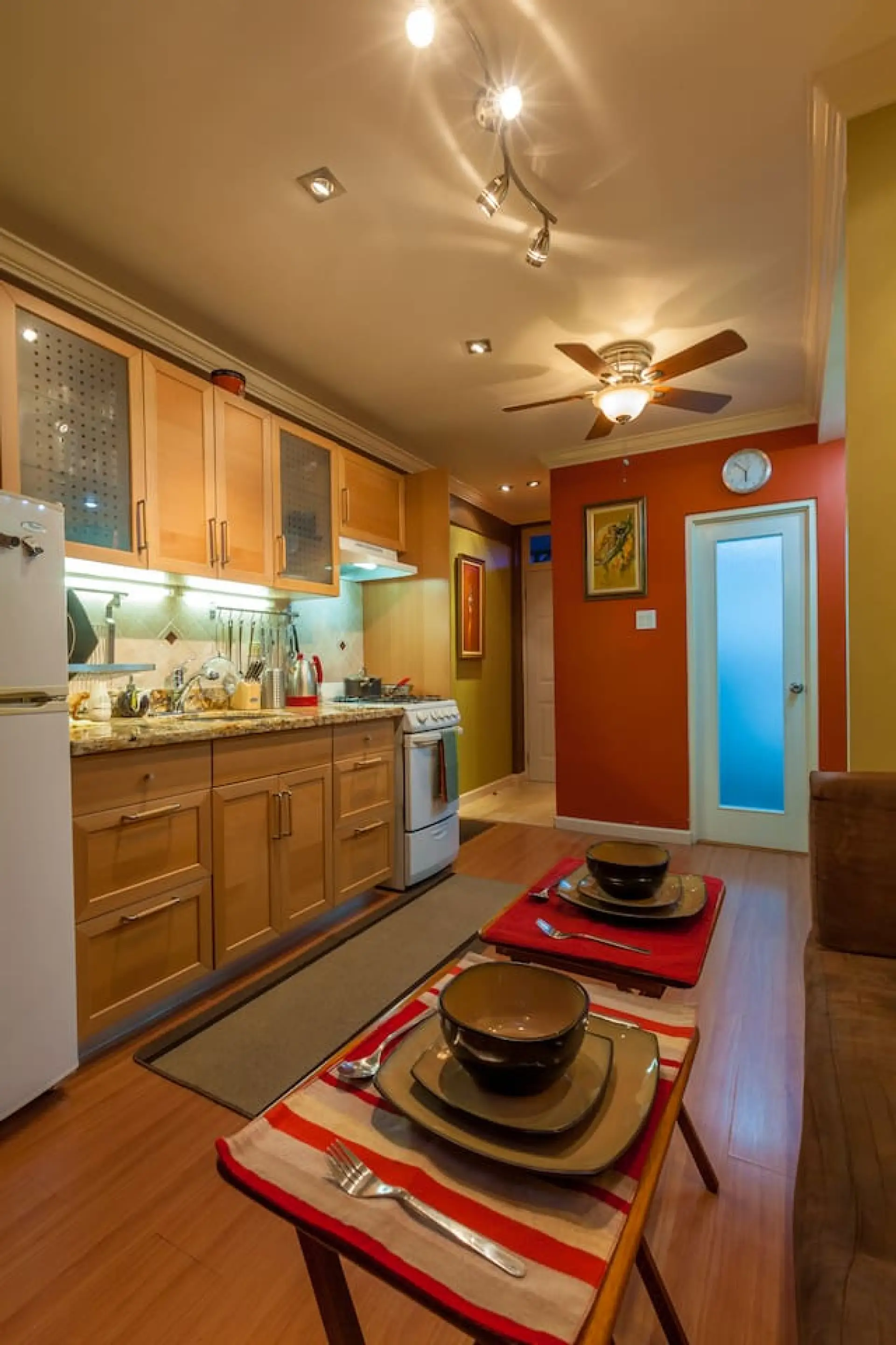 Bright kitchen w/ wood cabinets, tiled backsplash & everything set for easy meals at home