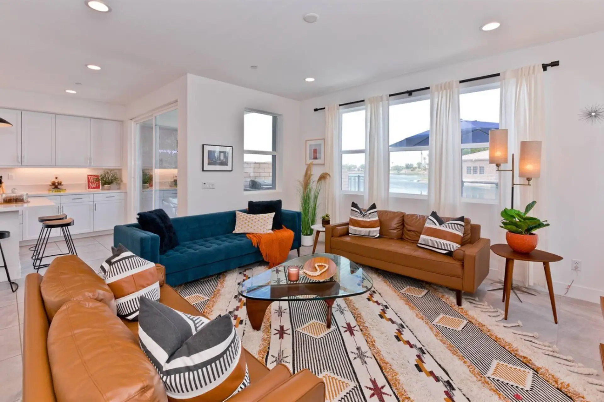 Unwind in stylish comfort in this spacious and sunlit living room. The perfect blend of mid-century modern and contemporary design creates a welcoming atmosphere for relaxation and entertainment.