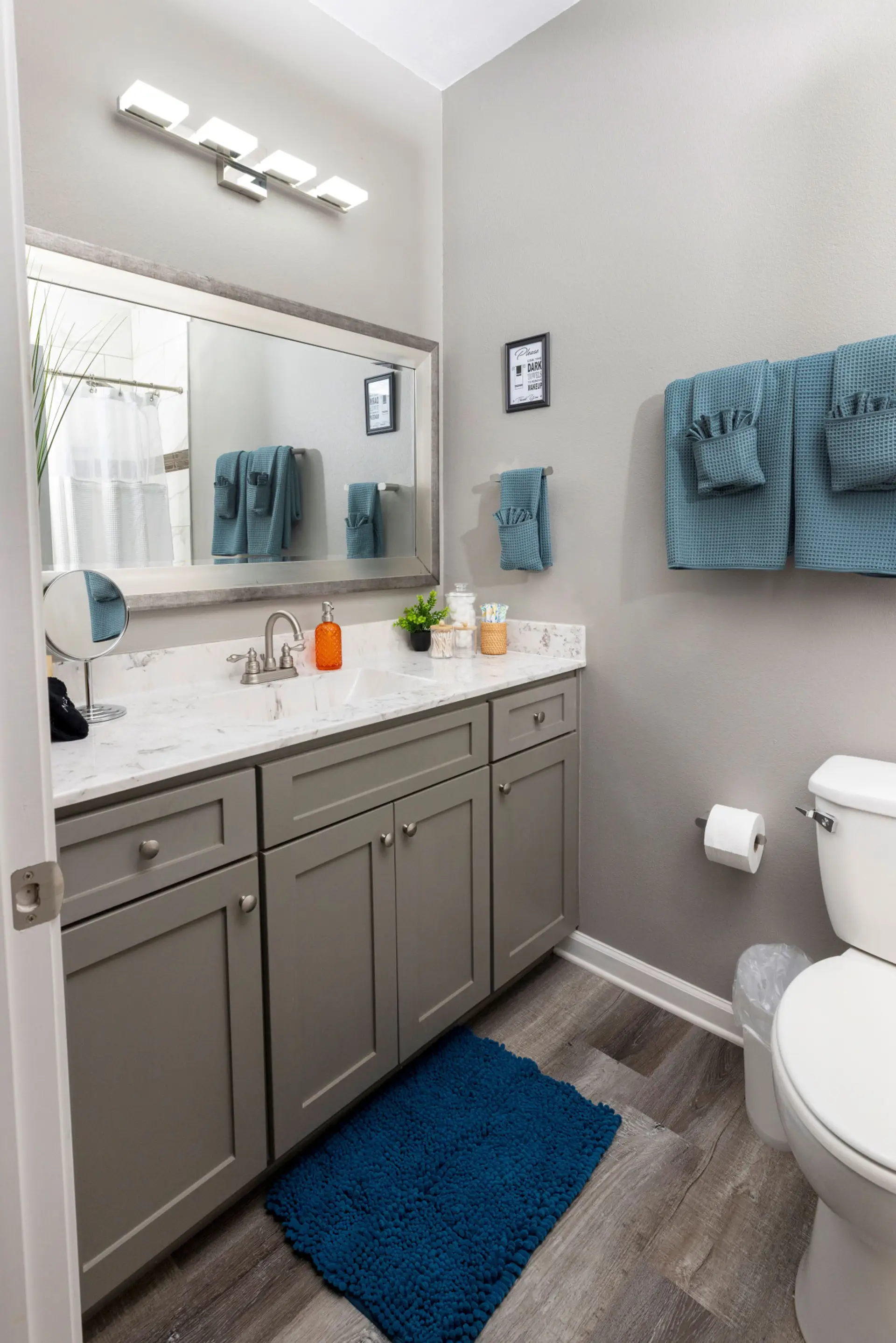Start your day in style with a spacious vanity, bathroom sink, and lush towels, stocked with bathroom essentials for your ultimate convenience.
