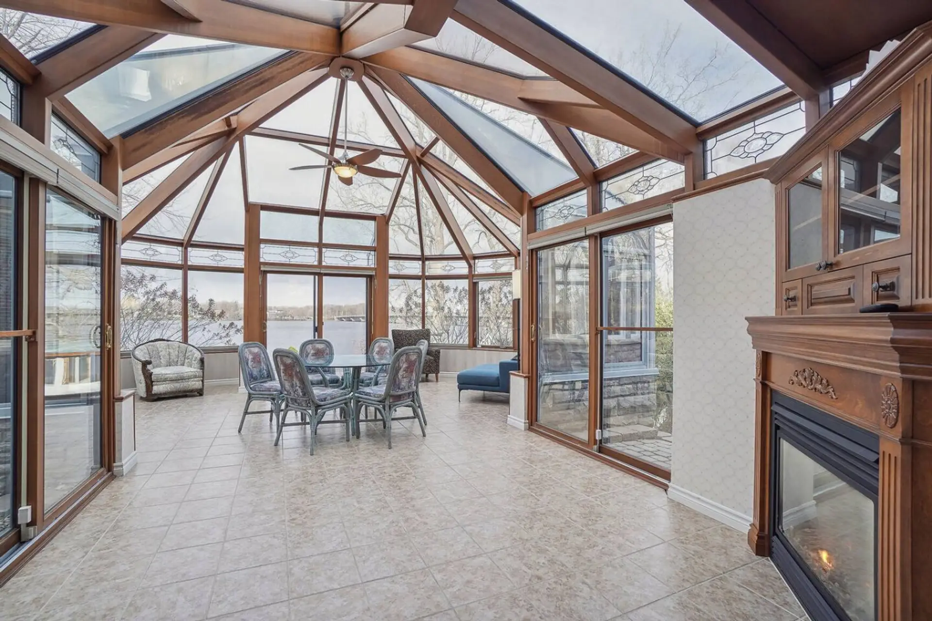 Solarium lumineux offrant un espace unique pour se rassembler tout en profitant de la vue extérieure.