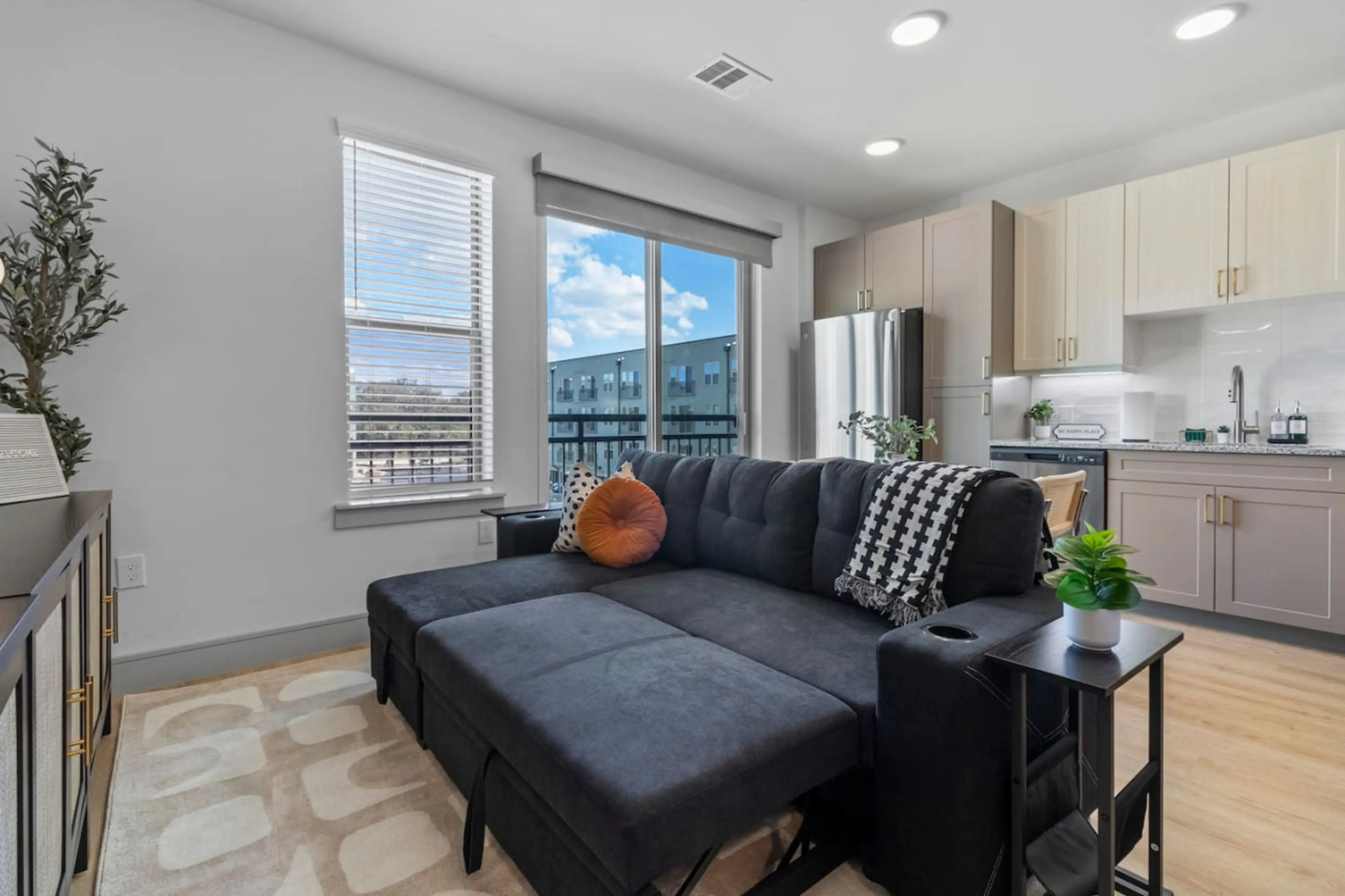 The living room’s cozy vibe makes it the perfect spot to relax, with ample seating and a warm ambiance.