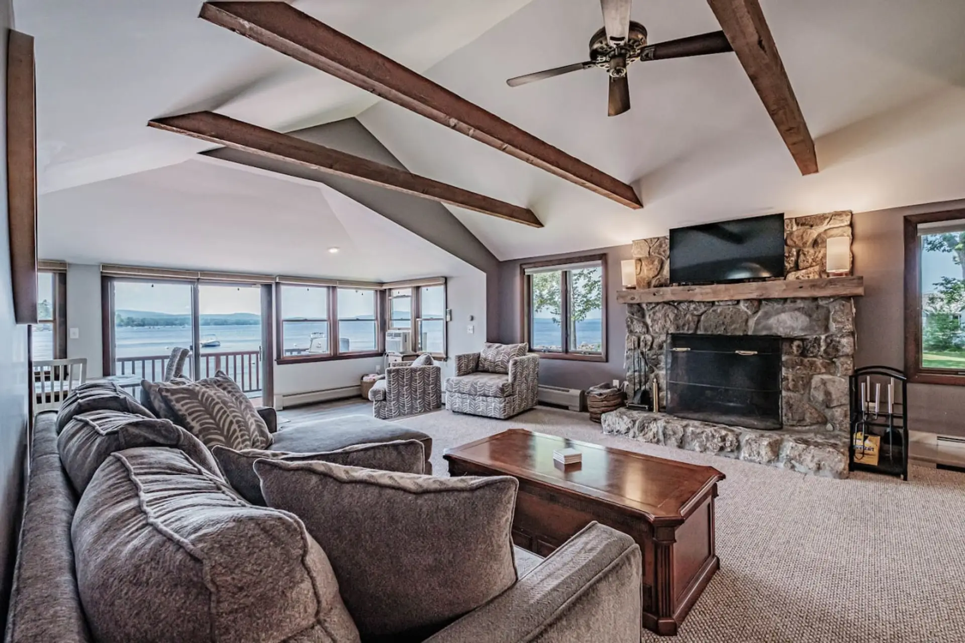 Open concept living and dining area with wood burning fireplace, smart TV, QUEEN sofa bed, AC window unit