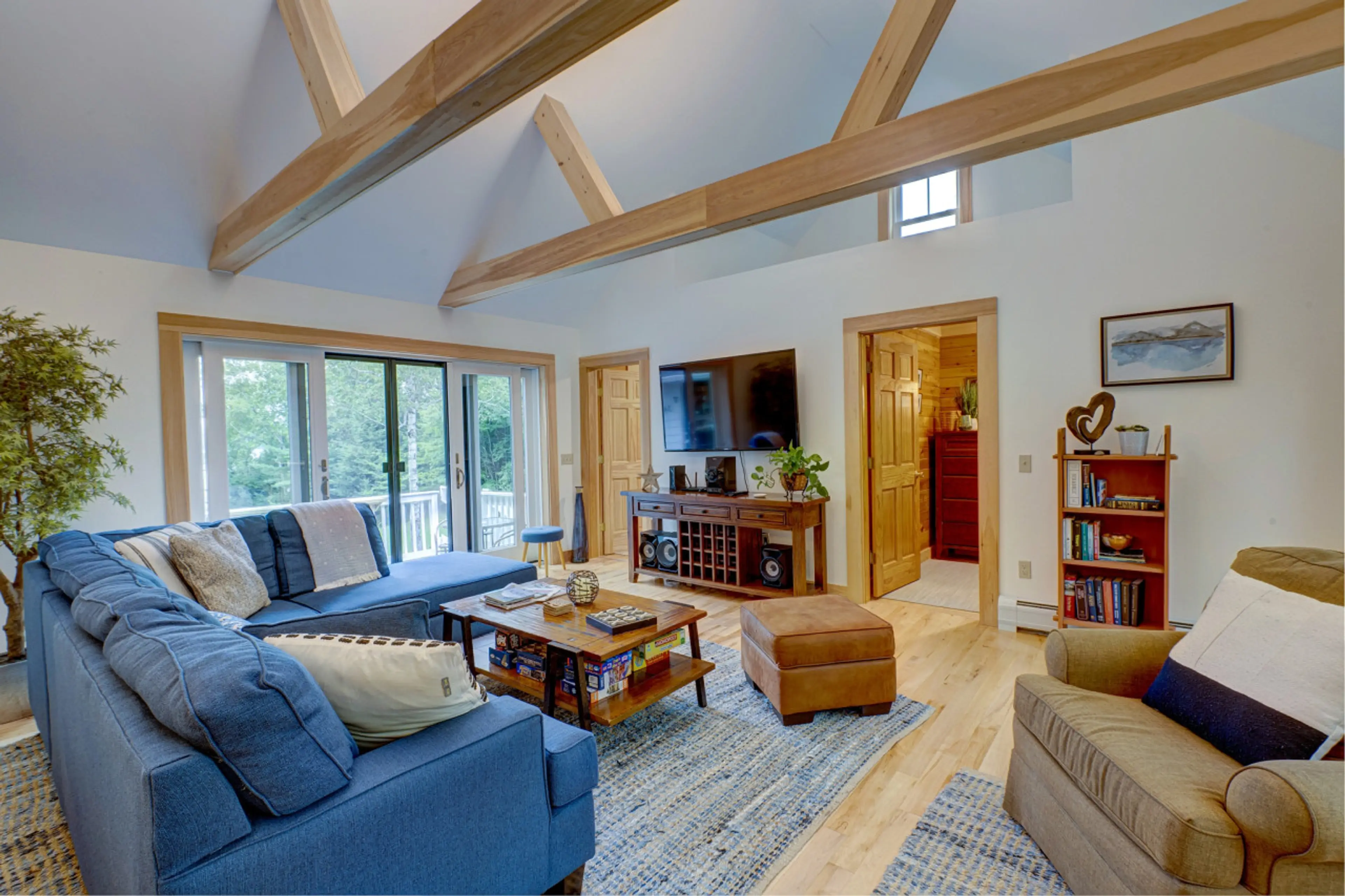 Large, cozy living room with doors out to a front deck and a 3rd deck out the backdoor.