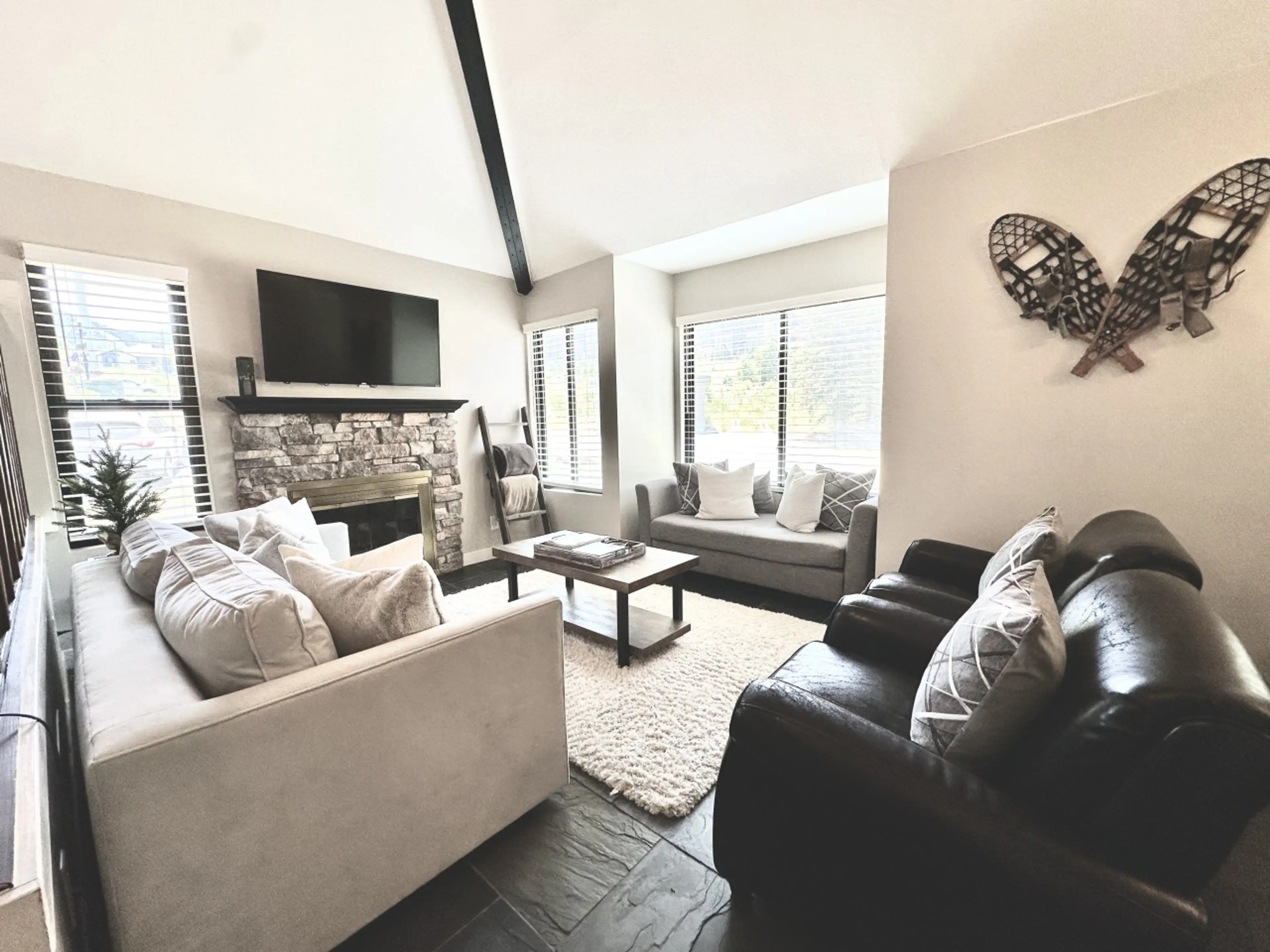 Gather, relax, and reconnect in this open-concept living area with soft seating and the glow of a traditional log fireplace