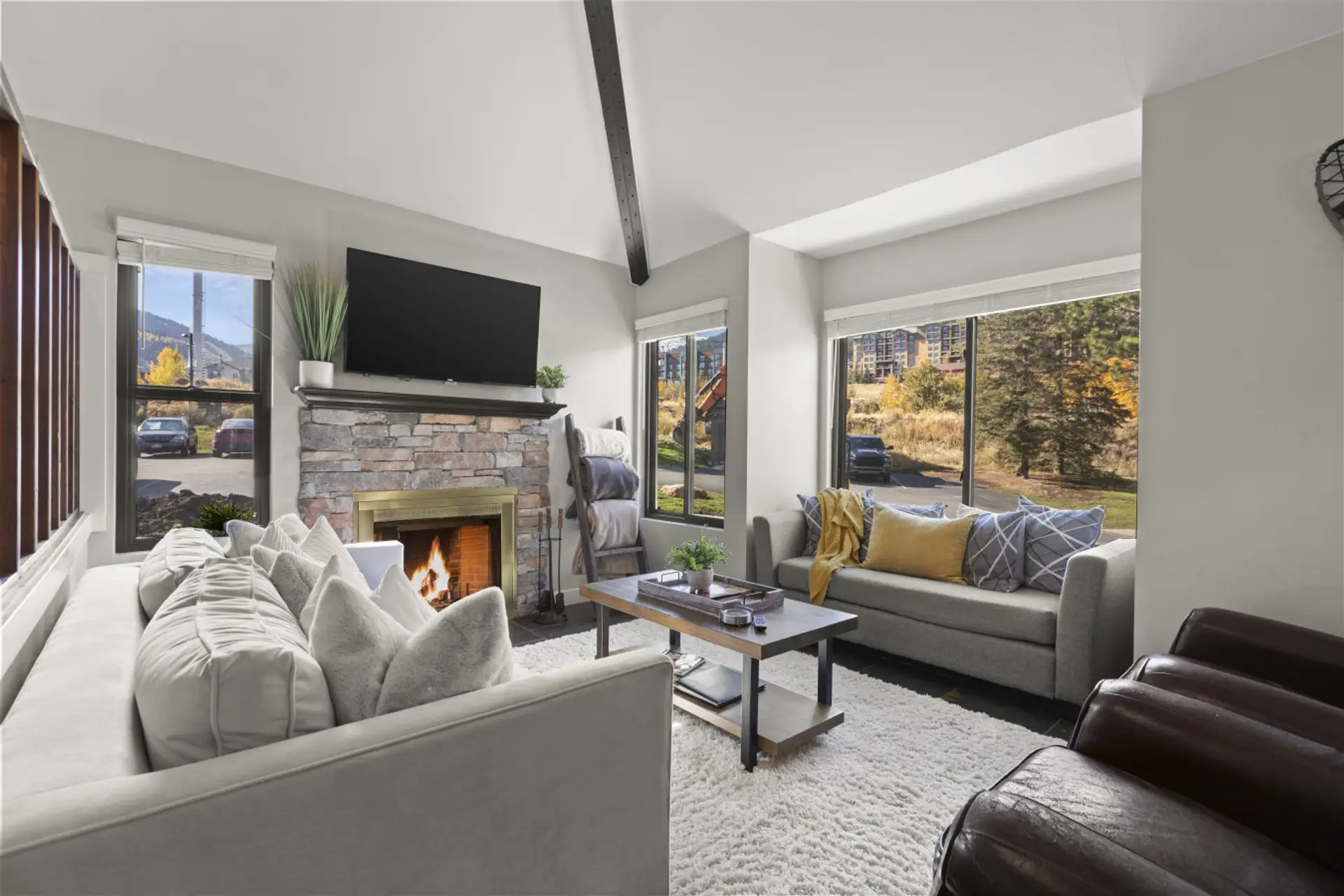 Gather, relax, and reconnect in this open-concept living area with soft seating and the glow of a traditional log fireplace