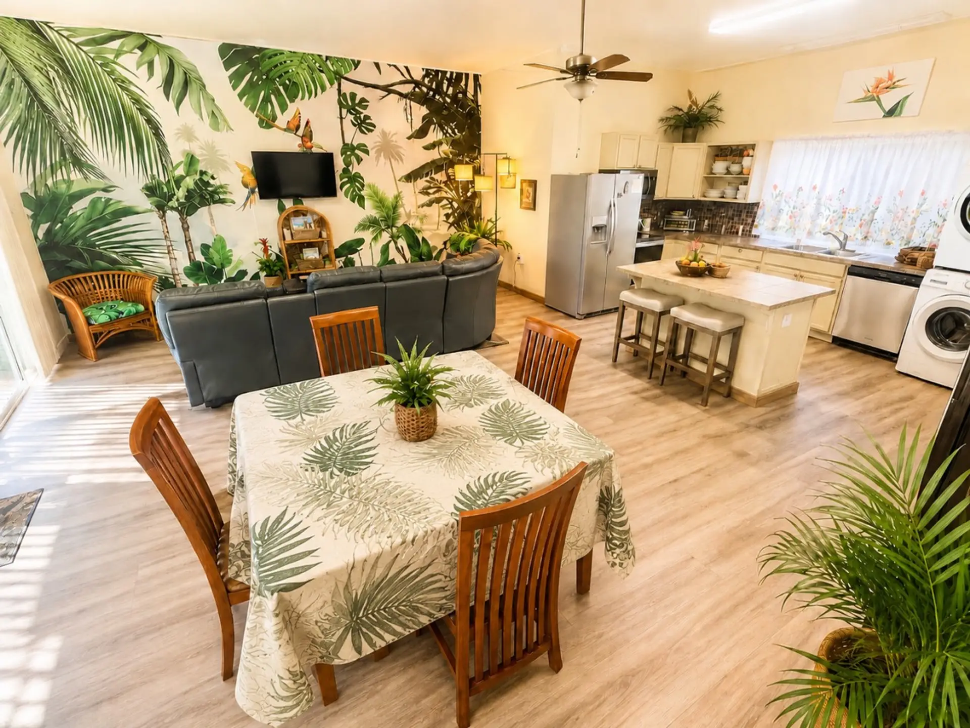 Spacious ground-floor living with an open kitchen, dining area, and lounge—perfect for families to spread out after island adventures. Enjoy cool Kona cloud forest vibes, plus a second upstairs TV room for movies, games, or extra space to relax.