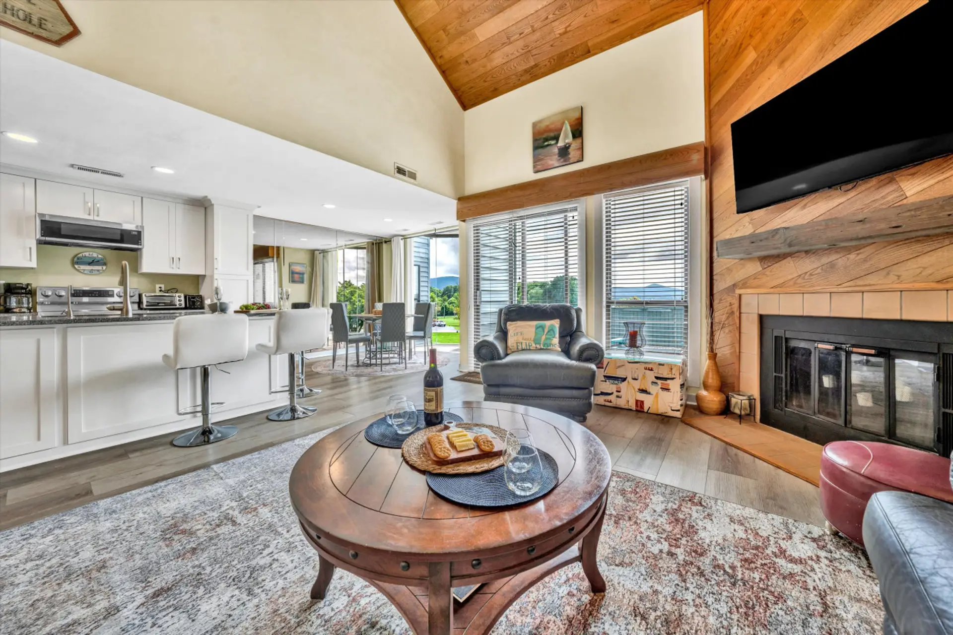 The living room's large windows let in natural light, creating a warm and inviting space.