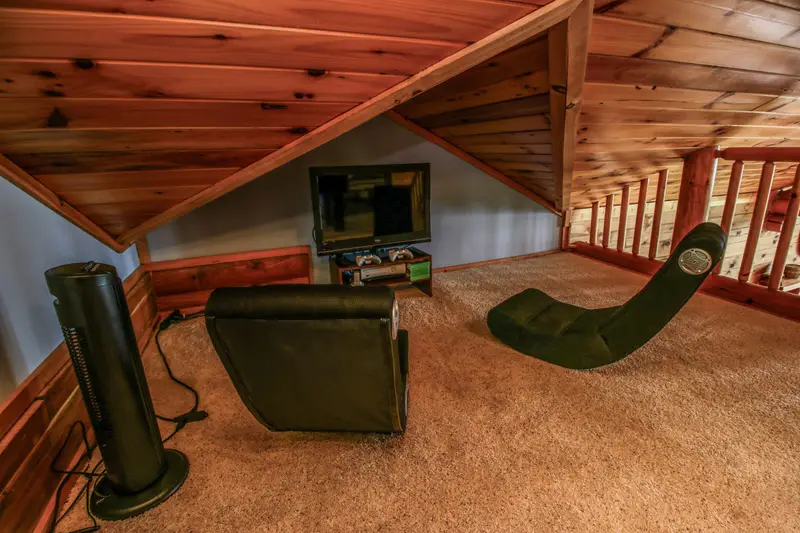 Loft entertainment corner with flat-screen TV, Xbox, and gaming chairs