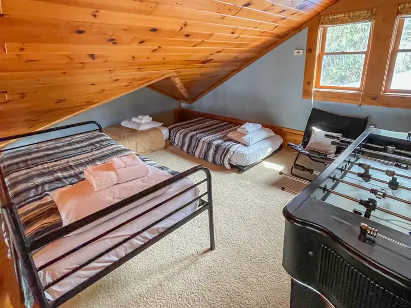 Loft with three twin beds and foosball table, perfect for kids and teens
