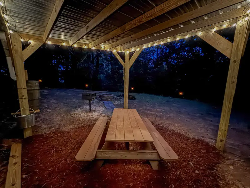 Picnic table under string lights at the retreat