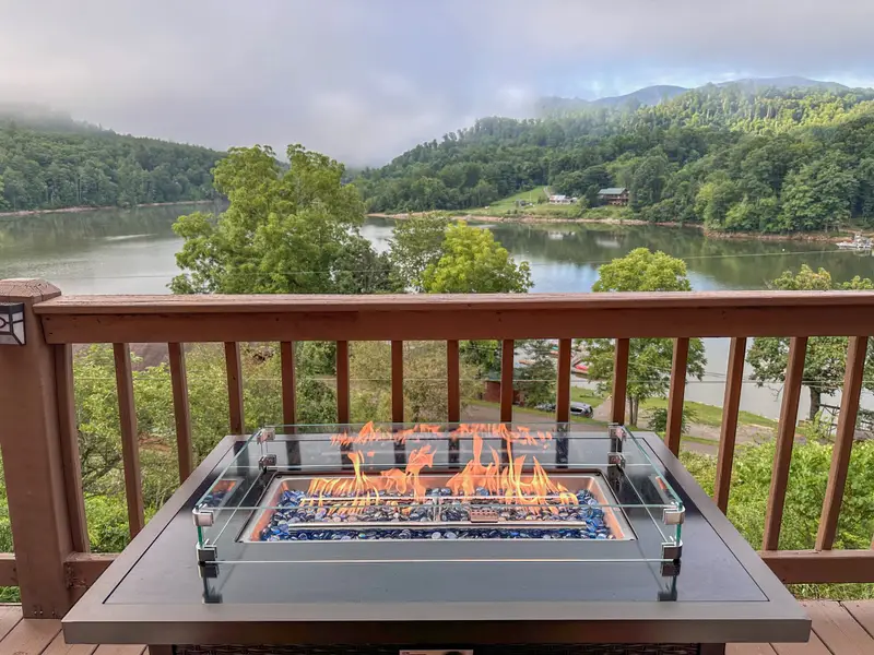 Fire table lit at dusk over the lake