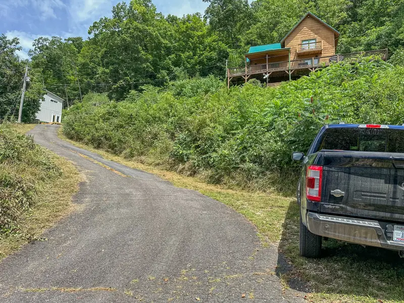 Paved driveway with parking for three cars