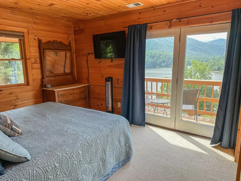 Upstairs king bedroom with private balcony overlooking the lake