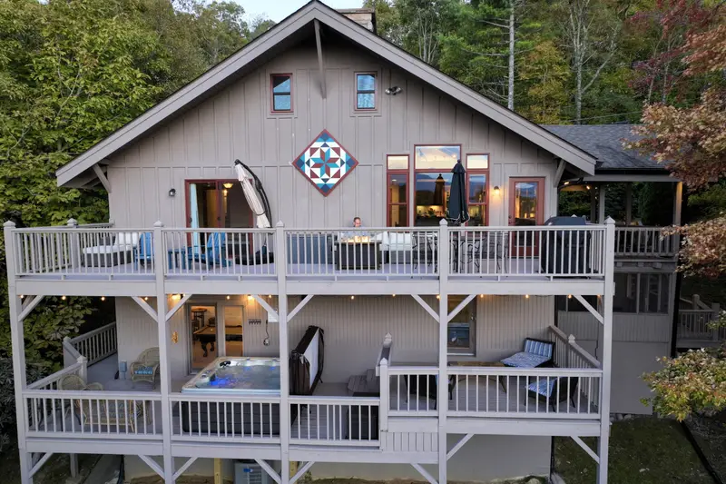 Rear exterior showing all three levels and two expansive decks