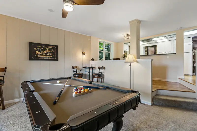 Game room with pool table, cornhole, and flat-screen TV