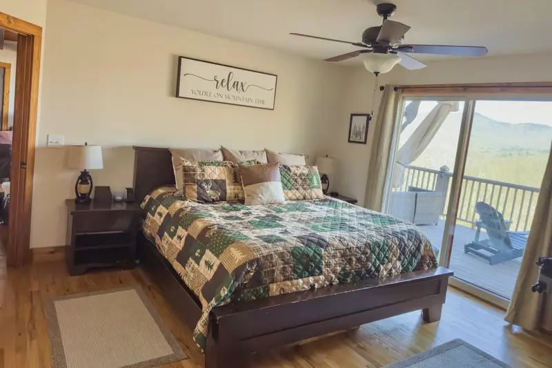 Main-level primary king bedroom with deck access