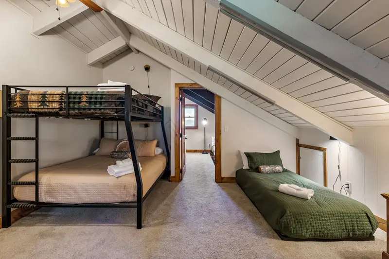 Bunk room with full-over-queen bunk and separate twin bed