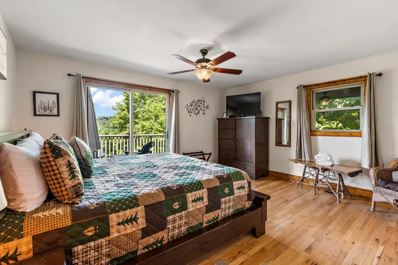 Primary king bedroom with walk-in closet and TV