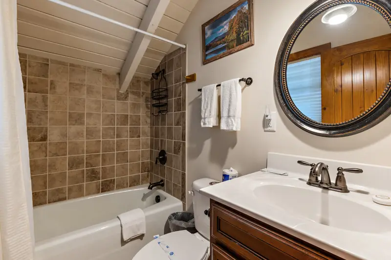Top-level ensuite bathroom with tub and shower