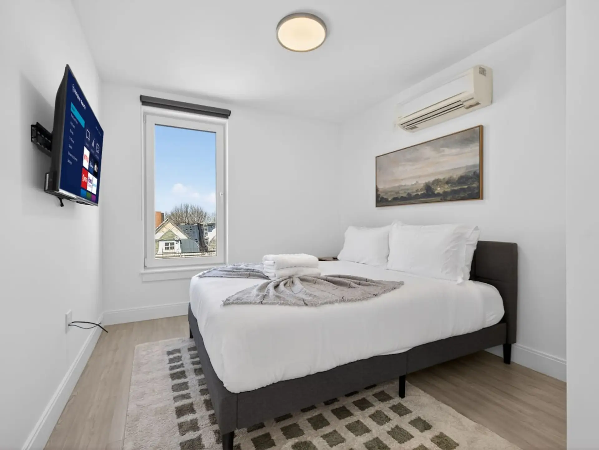Queen bedroom with Roku TV, fresh linens and individual climate control.