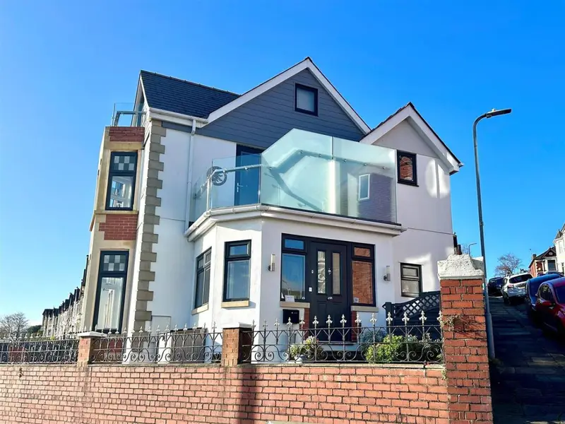 Open-plan living, kitchen and dining space with coastal views at Redlands House, Barry