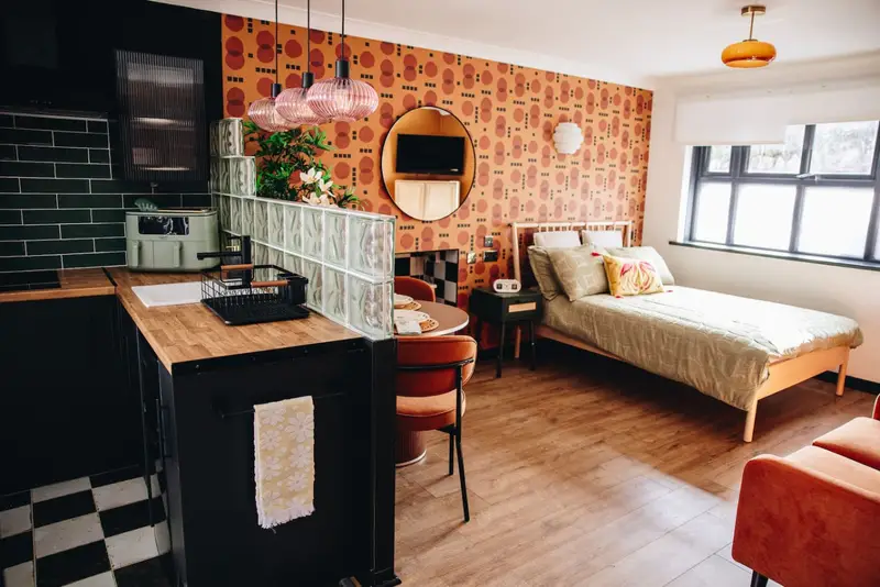 Retro-inspired studio annexe with seating area at 70's Hideaway, Penarth