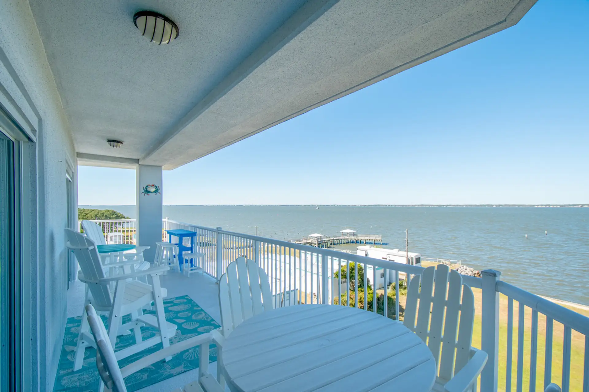 Enjoy morning coffee on the wraparound balcony overlooking the water