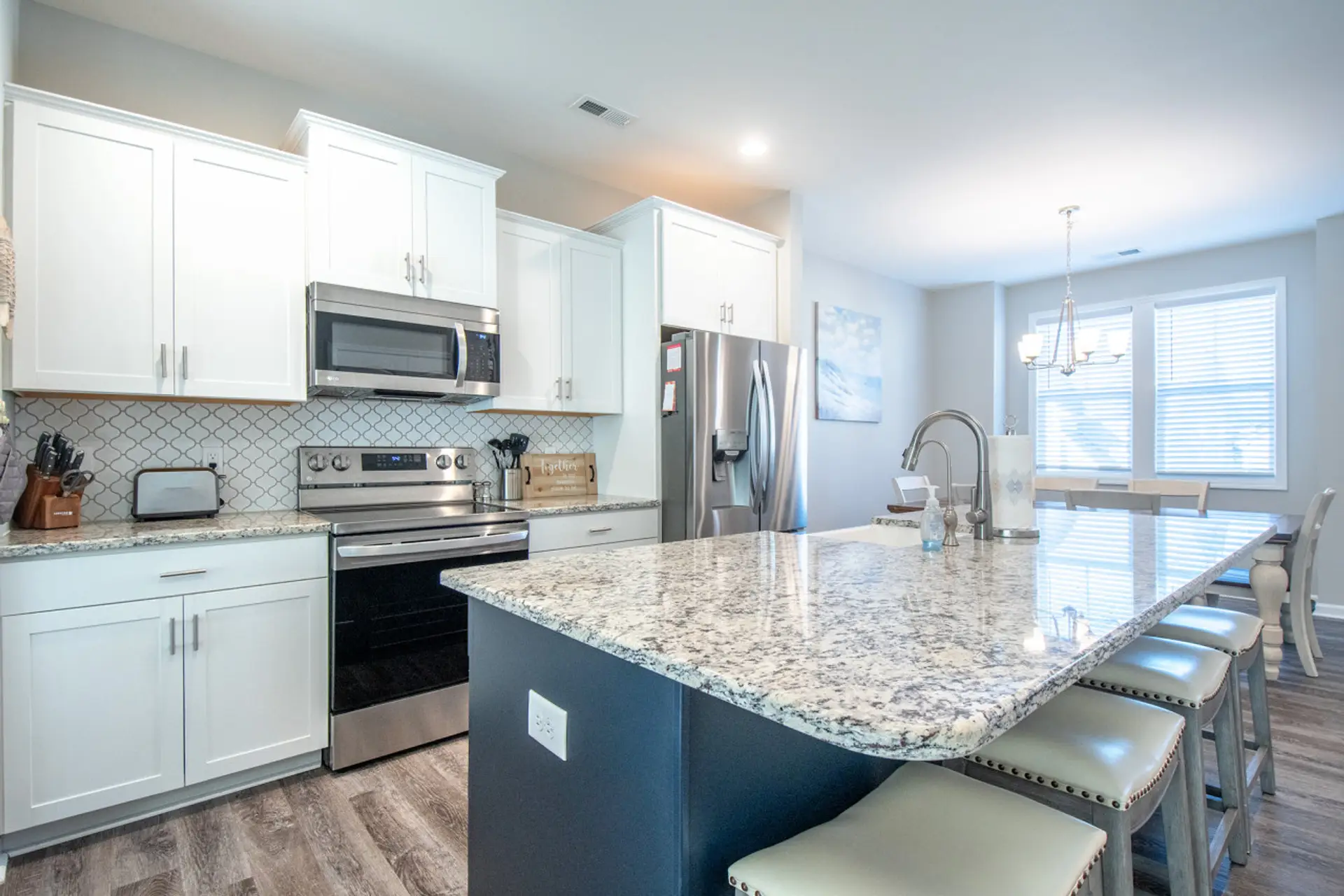 Cook and gather in this bright kitchen with a spacious island and cozy bar seating