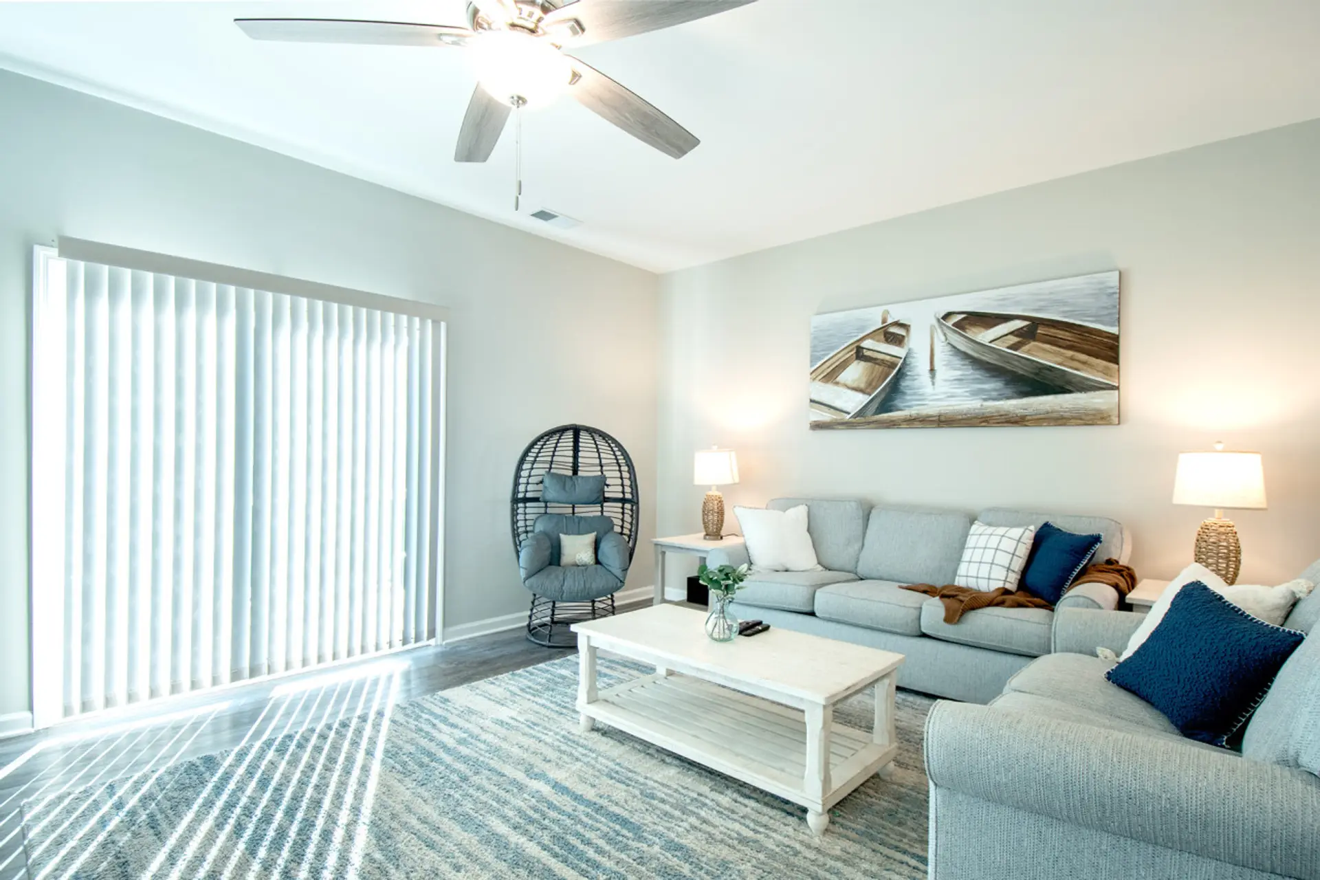 Inviting living space with stylish seating, natural light, and calming coastal accents