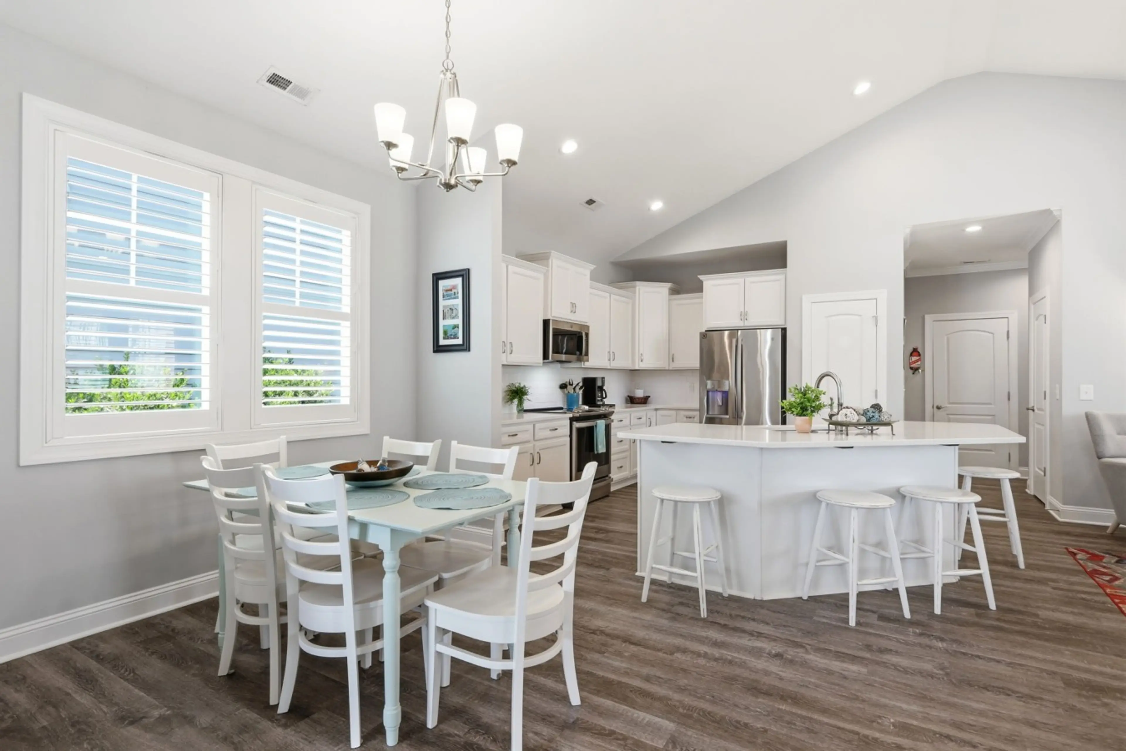 Enjoy an open-concept kitchen and dining space with seating for six and a spacious breakfast bar