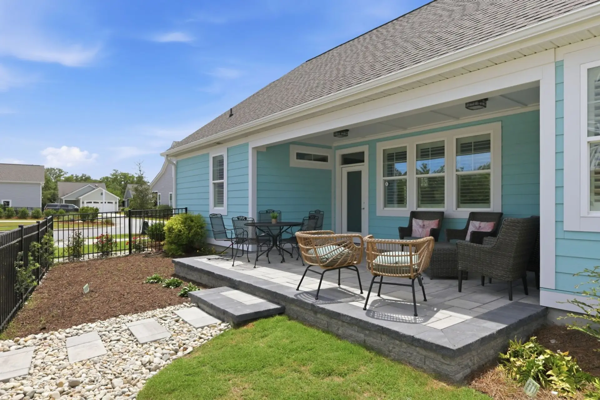 Relax, dine, and gather outdoors on this spacious covered patio designed for coastal living